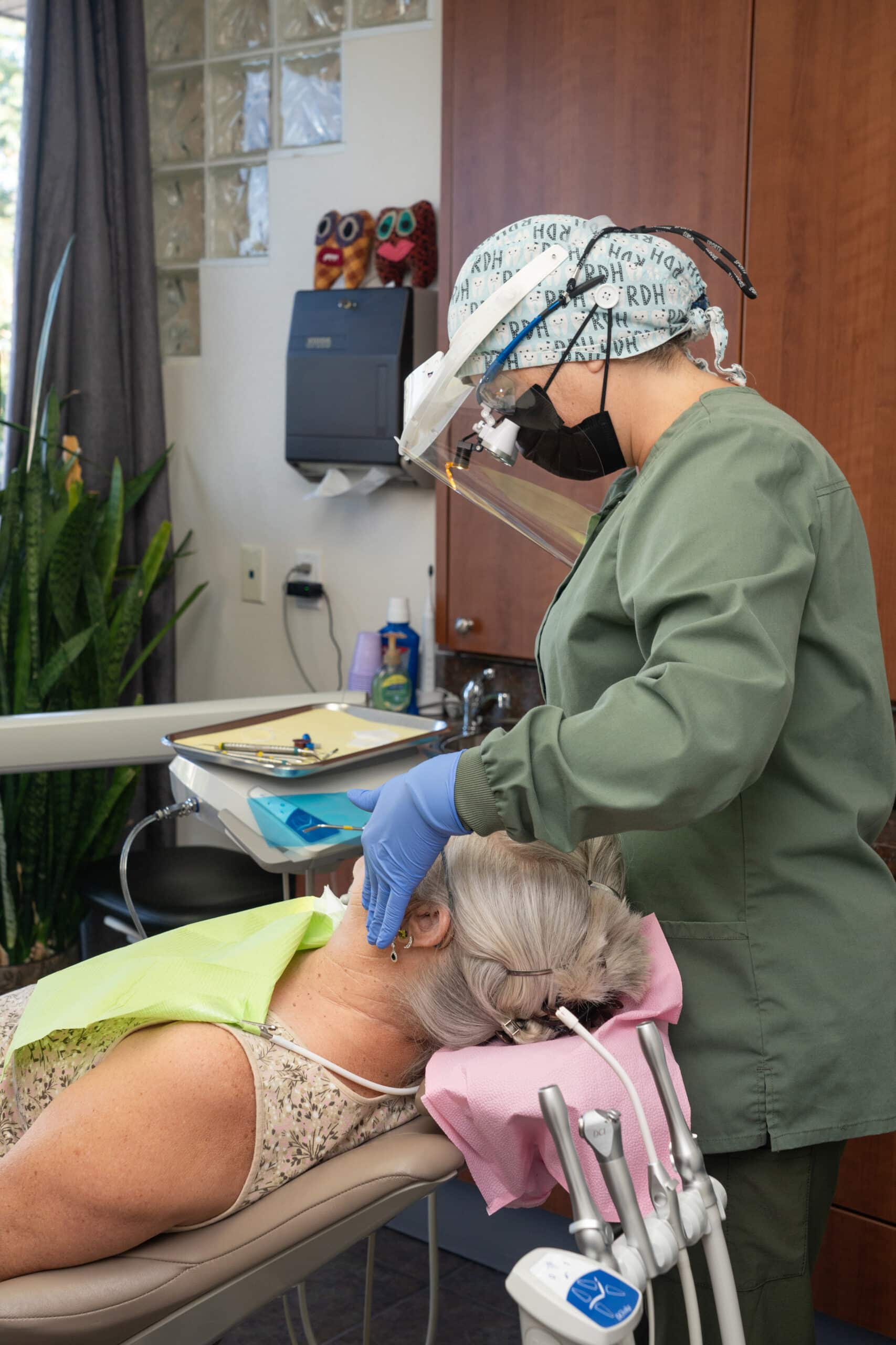 Dental hygienist working on senior patient - Oral Surgery in Littleton, CO