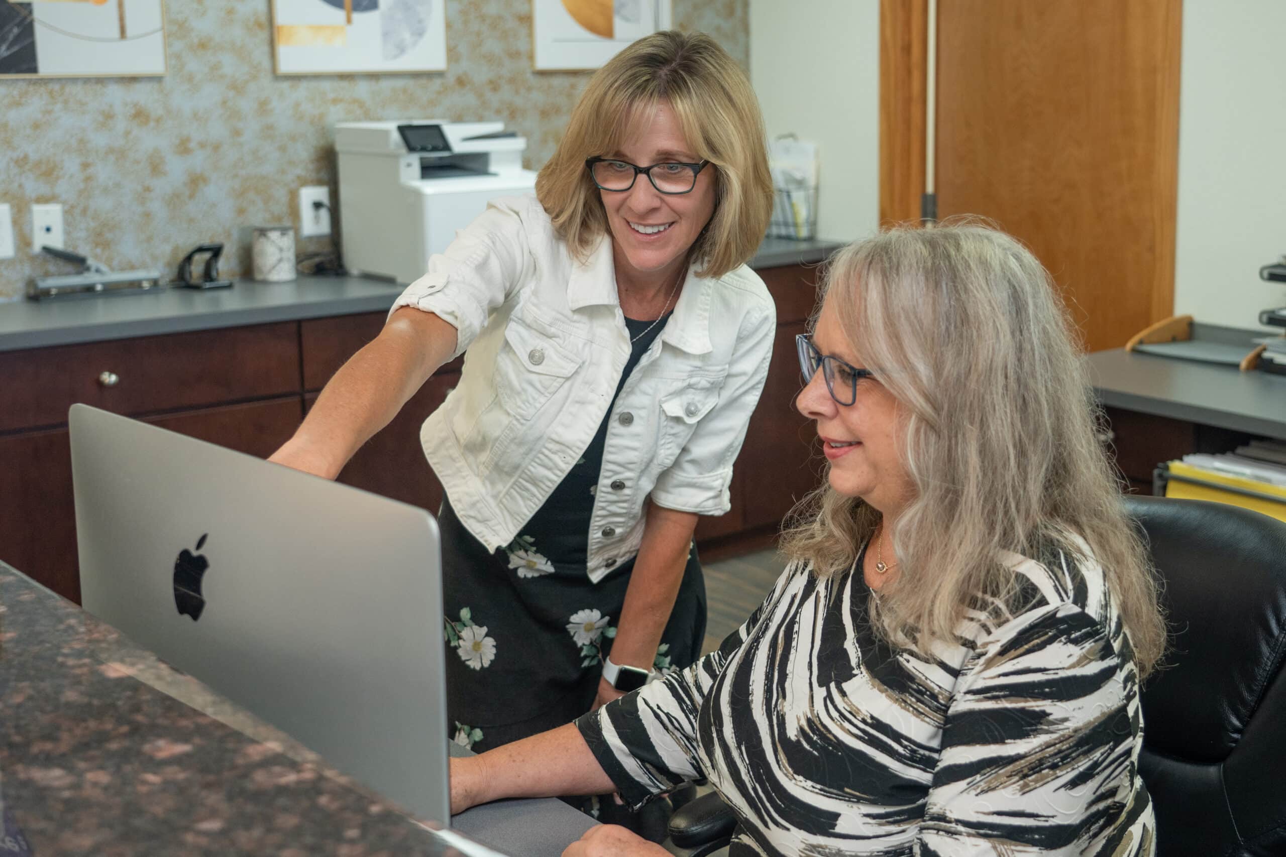 Dental admin assisting patient with digital form - Cosmetic Dentistry in Littleton, CO