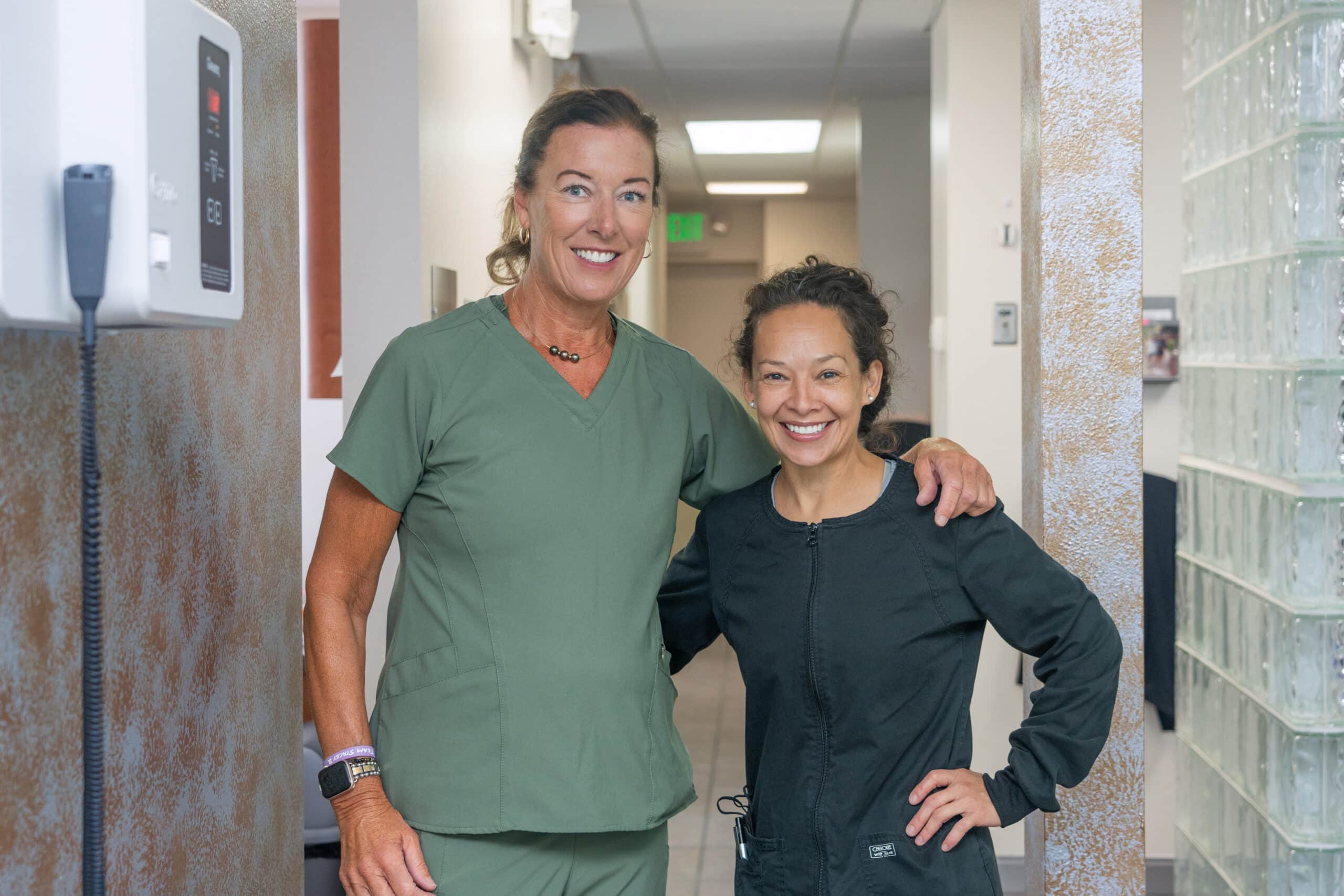 Two female staff members in hallway - Pediatric Dentistry in Littleton, CO
